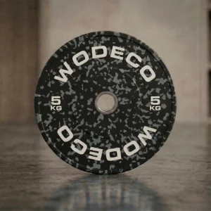 5 kg weight plate for barbells, black with gray speckle and white '5 KG' markings around the rim.”
