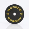 Black 15 kg weight plate for a barbell, yellow WODECO branding and center hole.