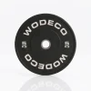 Black 5 kg weight plate with 'WODECO' lettering on white background, reflective surface visible underneath